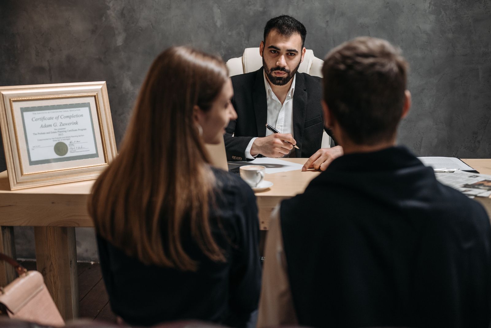 An attorney listening to clients during a private consultation